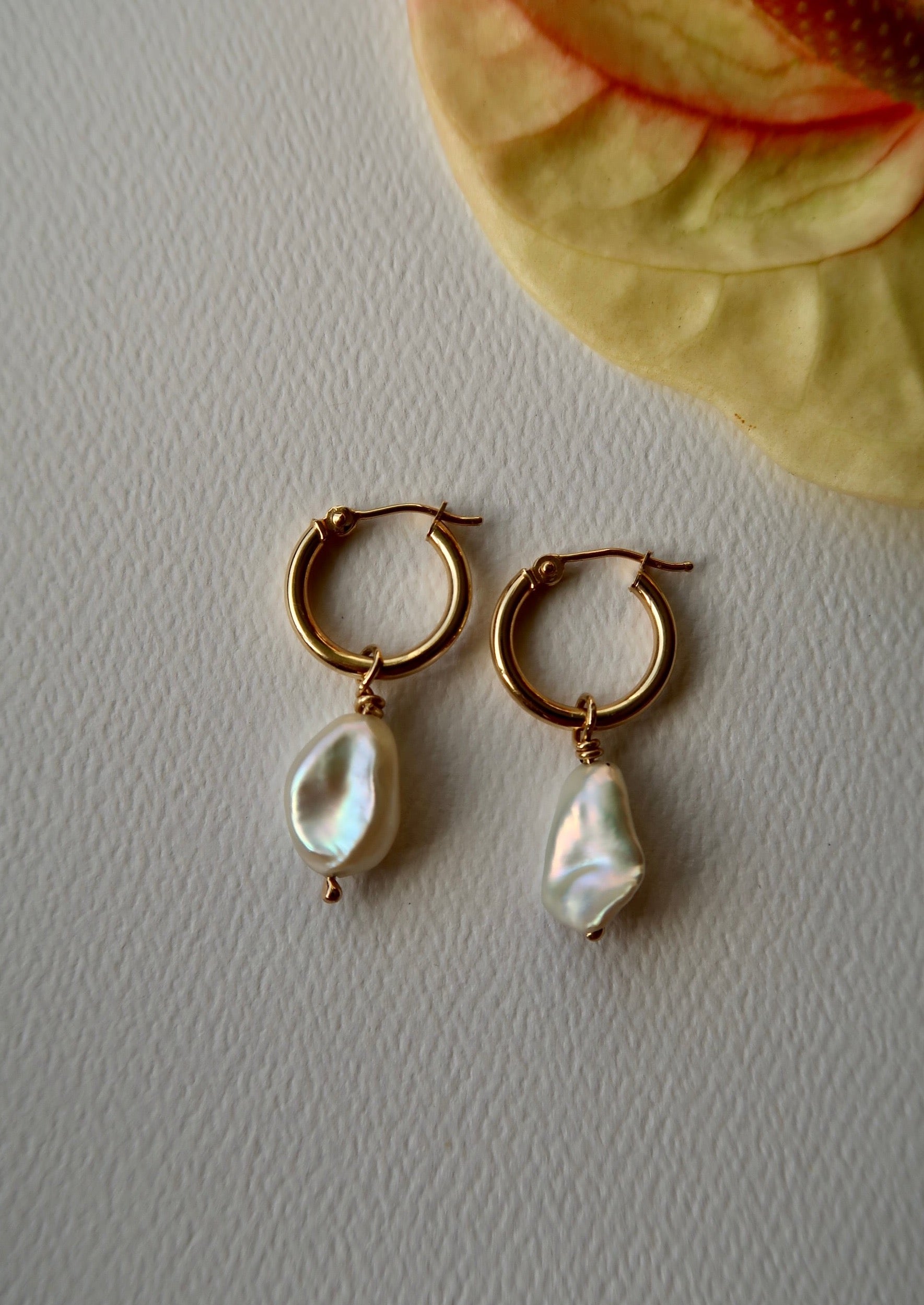 yellow gold hoops with white pearls